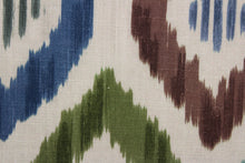 Load image into Gallery viewer, Aura features a multi-use geometric ikat design in shades blue, green and brown set against a bold khaki background. This durable fabric is rated for 30,000 double rubs. The versatile fabric is perfect for window accents (draperies, valances, curtains and swags) cornice boards, accent pillows, bedding, headboards, cushions, ottomans, slipcovers and upholstery.  
