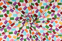 Load image into Gallery viewer,  This fabric features dancing spools of thread in rich and vibrant hues of red, yellow, orange, pink, green, purple and blue on a white background.  The versatile lightweight fabric is soft and easy to sew.  It would be great for quilting, crafting and sewing projects.  
