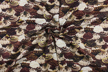 Load image into Gallery viewer, Celebrate your favorite sweet treat with this cute print of cupcakes from the &quot;Chocolicious&quot; collection.  The versatile lightweight fabric is soft and easy to sew.  It would be great for quilting, crafting and sewing projects.  Colors include shades of brown, cream and lime green.
