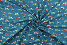 Load image into Gallery viewer, Embrace the Holiday season with Cherry Guidry&#39;s Heart &amp; Home Collection.  This cheerful print features trucks carrying gifts and trees.  The versatile lightweight fabric is soft and easy to sew.  It would be great for quilting, crafting and sewing projects.  Colors include blue, red, black, white and shades of green.
