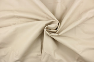 This vinyl fabric features a smooth design in pale beige. 