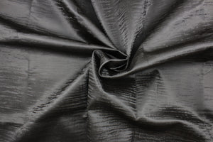 This vinyl fabric features a smooth velvet look in dark gray . 
