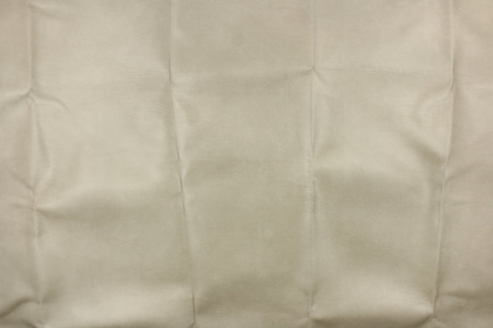 This upholstery weight faux leather fabric in a light taupe has a soft flannel backing and can be used for upholstery projects, picture frames, pillows, headboards craft projects, purses, fashion accessories and more!