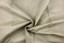 Load image into Gallery viewer, This upholstery weight faux leather fabric in a light taupe has a soft flannel backing and can be used for upholstery projects, picture frames, pillows, headboards craft projects, purses, fashion accessories and more!

