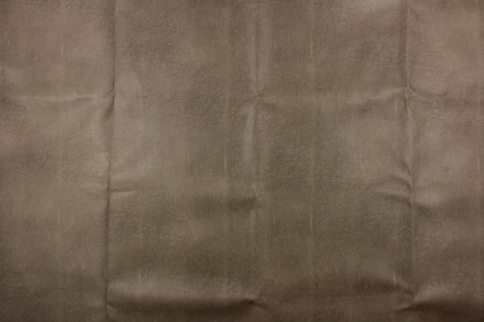 This upholstery weight faux leather fabric in a rich brown has a soft flannel backing and can be used for upholstery projects, picture frames, pillows, headboards craft projects, purses, fashion accessories and more! 
