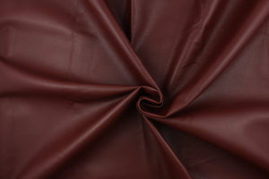 This vinyl fabric features a crackle design in rich reddish brown.