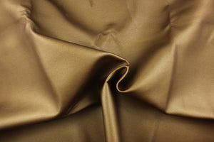 This vinyl fabric features a smooth  design in bronze tone.