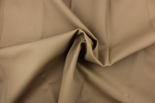 This vinyl fabric features a light crackle design in tan. 