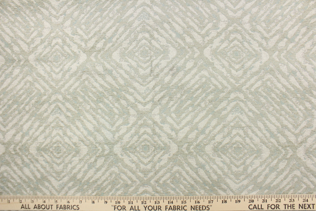 This fabric features a geometric design in pale green, with hints of blue and gray.