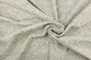 This fabric features a geometric design in pale green, with hints of blue and gray.