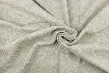 Load image into Gallery viewer, This fabric features a geometric design in pale green, with hints of blue and gray.
