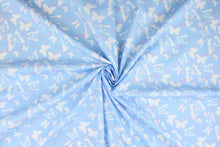 Load image into Gallery viewer, Think of a warm, sunny, summer day with this fabric featuring large and small butterflies in pink and white on a baby blue background.  The versatile lightweight fabric is soft and easy to sew.  It would be great for quilting, crafting and sewing projects.  

