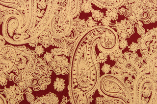  This fabric features a large paisley print in light orange on a red background.  The versatile lightweight fabric is soft and easy to sew.  It would be great for quilting, crafting and sewing projects.  