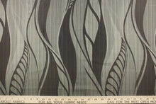Load image into Gallery viewer, Bena is a large leaf jacquard fabric from the &quot;Hit The Road Collection&quot;.  It offers beautiful design, style and color to any space in your home.  It has a soft workable feel and is perfect for window treatments (draperies, valances, curtains, and swags), light upholstery, bed skirts, duvet covers, pillow shams and accent pillows.  It has an abrasion rating of 15,000 double rubs.  Colors include dark brown, sandy beige and blue grey.
