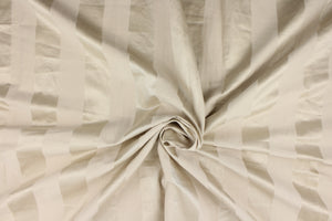 This fabric features a stripe design in pale beige with  a slight shine. 