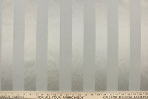 This fabric features a stripe design in gray with  a slight shine. 