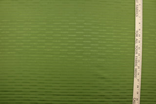 This duotone striped jacquard fabric in pea green is durable and hard wearing with a rating of 30,000 double rubs.  It can be used for multi purpose upholstery, bedding, accent pillows and drapery.  