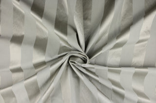 This fabric features a stripe design in gray with  a slight shine. 