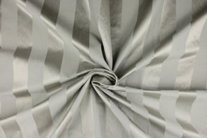 This fabric features a stripe design in gray with  a slight shine. 