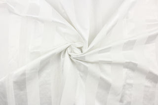 This fabric features a stripe design in bright white with  a slight shine. 