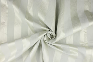 This fabric features a wide stripe design in pale gray with green undertones and a slight shine. 