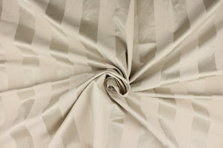 This fabric features a wide stripe design in a pale taupe  with  a slight shine.