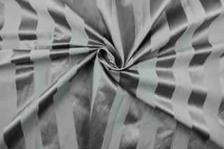 This fabric features a stripe design in gray with a slight shine. 