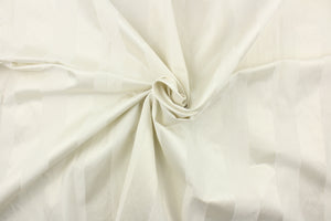 This fabric features a stripe design in off white with  a slight shine. 