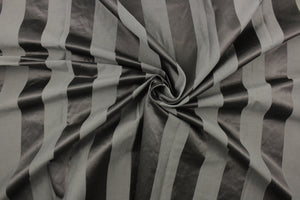 This fabric features a stripe design in dark gray with  a slight shine. 