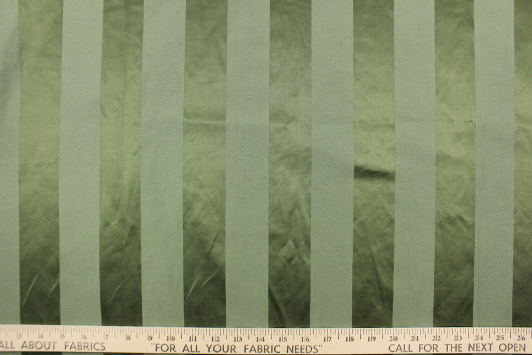 This fabric features a stripe design in green with  a slight shine.