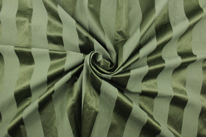 This fabric features a stripe design in green with  a slight shine.