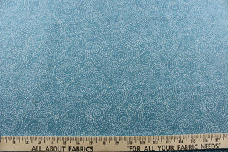This whimsical print offers bold colors and simplicity, with a simple design of swirls of  tiny white dots on a mineral blue background. 
