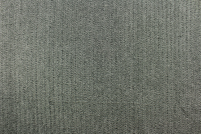 This wool features a herringbone design in green and white .