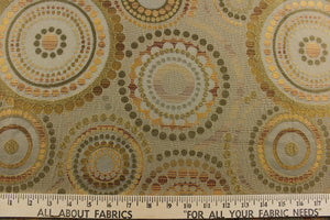 This contemporary geometric design features overlapping circles and dots in beige, brown, gold, green and copper colors.