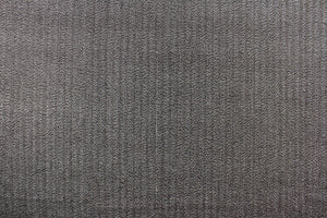  This wool features a herringbone design in brown and white with hints of tan .