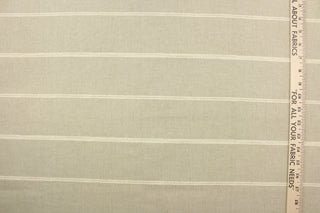 This fabric features a horizontal stripe design in cream against light beige. 