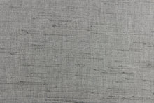 Load image into Gallery viewer,  Voltaire is a woven, textured fabric in silver grey.  It has a slub yarn running across the the fabric which creates the look of silk with a soft, drapable hand.  The weight is suited for draperies, light upholstery, headboards, decorative pillows, coverlets and cornice boards.  We offer Voltaire in several different colors.
