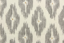 Load image into Gallery viewer, This geometric medium scale ikat design in gray and tan against white . 
