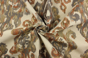  This fabric features a watercolor demask design in orange, coral, gray, gold and beige against a pale beige. 