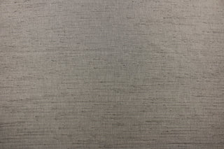  Voltaire is a woven, textured fabric in dark grey.  It has a slub yarn running across the the fabric which creates the look of silk with a soft, drapable hand.  The weight is suited for draperies, light upholstery, headboards, decorative pillows, coverlets and cornice boards.  We offer Voltaire in several different colors.