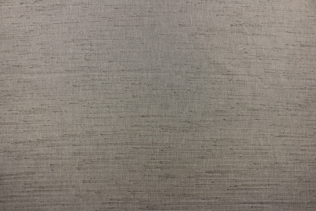  Voltaire is a woven, textured fabric in dark grey.  It has a slub yarn running across the the fabric which creates the look of silk with a soft, drapable hand.  The weight is suited for draperies, light upholstery, headboards, decorative pillows, coverlets and cornice boards.  We offer Voltaire in several different colors.