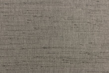 Load image into Gallery viewer,  Voltaire is a woven, textured fabric in dark grey.  It has a slub yarn running across the the fabric which creates the look of silk with a soft, drapable hand.  The weight is suited for draperies, light upholstery, headboards, decorative pillows, coverlets and cornice boards.  We offer Voltaire in several different colors.
