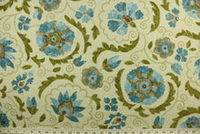 Load image into Gallery viewer, This multi purpose fabric features a floral and vine design in shades of blue, brown, dark khaki and olive green on a beige background. It can be used for several different statement projects including window accents (drapery, curtains and swags), decorative pillows, hand bags, bed skirts, duvet covers, upholstery and craft projects.  It has a soft workable feel yet is stable and durable.
