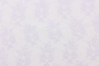This lace features a small woven floral design in a pale purple . 