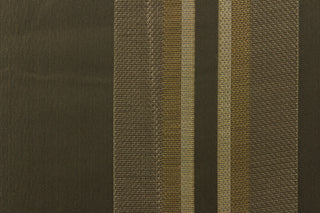 This rich woven yarn dyed fabric features bold multi width striped pattern in shades of pewter and gold on a dark brown background. 