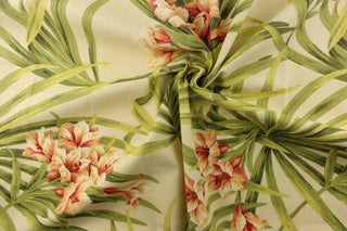 A beautiful large floral print in green, peach, coral, pink, orange and red set against a cream background.