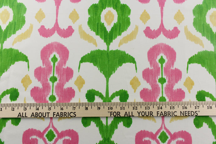 This fun design features an ikat pattern in  pink, green and yellow colors on a white background. 
