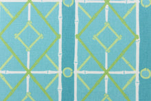 Load image into Gallery viewer,   This very unique fabric with a tropical theme, feature a geometric pattern of bamboo looking diamonds, stripes and circles in a cabana blue color with lime green and turquoise blue colors along with some white strips.
