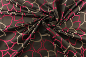 This elegant jacquard fabric features a woven floral design in a deep pink and taupe against a dark brown. 