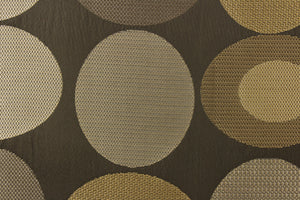 Geometric pattern of circles and ovals in gold and pewter tones on a brown gray background